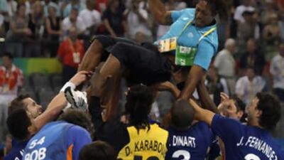 Former handball player Jackson Richardson is lifted by France's men's handball team after defeating Iceland in the gold medal match at the Beijing 2008 Olympics in Beijing, Aug 24 2008.