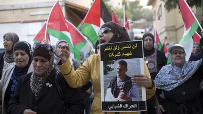 Jerusalem activist Ranya Hatem, 38, from Mount of Olives, holds a poster of Kheir Hamdan in Kfar Kana November 10,2014. The women and men came from the different neighbourhoods of Jerusalem to show their support to the family of Kheir.
