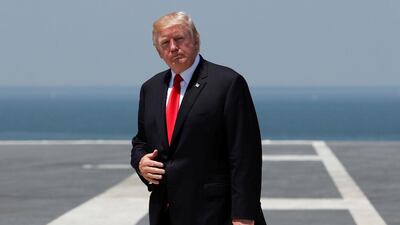 President Donald Trump walks to board Marine One on the flight deck of the USS Gerald R. Ford aircraft carrier. AP