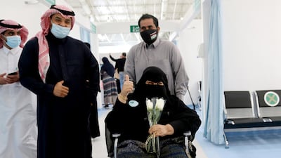 A Saudi woman gestures after she received the first dose of a coronavirus disease vaccine, in Riyadh, Saudi Arabia. Reuters