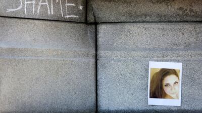 The word shame is written on the Confederate monument near a photograph of Heather Heyer, the woman who was killed on August 12, 2017 during protests in Charlottesville.. Steve Earley / The Virginian-Pilot via AP
