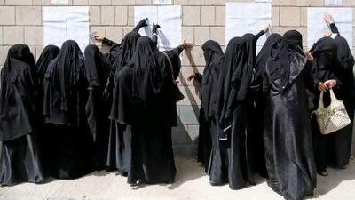 Female voters check voting rolls in the Al Hasaba neighbourhood of Sanaa yesterday.