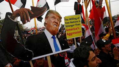 Supporters of Iraqi Shiite cleric Moqtada Al Sadr carry placards depicting US President Donald Trump at a protest. Reuters