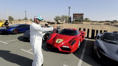 A Ferrari Enzo flanked by a McLaren P1 and two Lamborghini Aventadors, all belonging to members of Supercars Club Arabia. Chris Whiteoak / The National