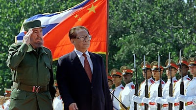 Fidel Castro reviews a guard of honour with visiting Chinese President Jiang Zemin in Havana, April 12, 2001. AFP