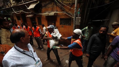 Municipal workers clear the debris from the site of collapsed building. EPA