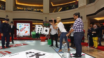 Each player is given one of the familiar 'tokens', such as a hat, dog, thimble or racing car, and they throw a large dice to make their way around the board.