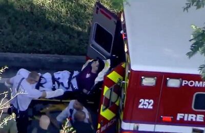 A man who was placed in handcuffs by police is loaded into a paramedic vehicle after a shooting incident at Marjory Stoneman Douglas High School in Parkland, Florida, U.S. February 14, 2018 in a still image from video. WSVN.com via Reuters