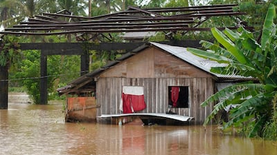 A house lies partly underwater after tropical storm Agaton swept through the southern Philippines.