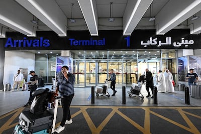 Passengers arrive at Kuwait International Airport in Kuwait city. AFP