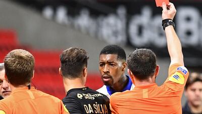 French referee Ruddy Buquet shows a red card to Paris Saint-Germain's French defender Presnel Kimpembe. AFP