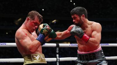 John Ryder throws a punch at Saul Alvarez. Reuters