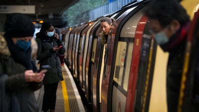 Commuters getting on a Jubilee Line Underground train at Canning Town station in London. AP Photo