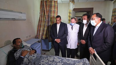 The prime minister visits one of the 14 people in hospital after the blaze. AFP