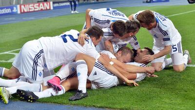 Oleh Husyev, second from bottom, of Dynamo Kiev celebrates with teammates after scoring in their 2-2 draw with FC Porto in the Champions League on Wednesday night. Genya Svilov / AFP
