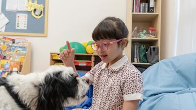 Hind Algaith, 6, plays with Ziggy during a one-on-one session.