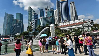 7th: Singapore. Tourists visit Singapore’s famous Merlion in front of the skyline of the city’s financial business district. Roslan Rahman / AFP