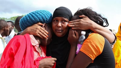 Survivors comfort each other at the military camp in Garissa town, about 370km northeast of the Kenyan capital Nairobi, after Al Shabab gunmen attacked the local university on Thursday. Daniel Irungu / EPA / April 3, 2015
