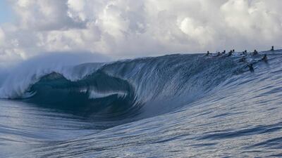 Surfers wait on the crest of the wave ahead of the WSL Tahiti pro surfing trial at the famous break Teahupoo in Tahiti, French Polynesia. AFP