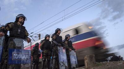 Macedonian special police forces secure the gate open for the international train at the border with Greece, near Gevgelija. Georgi Licovski / EPA