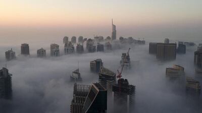 Skyscrapers are seen amidst the clouds on a foggy morning in Dubai on December 5, 2016. Rene Slama / AFP