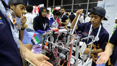 Members of UAE team work on their robot at the First Global Challenge robotics competition held at Festival Arena in Dubai. All photos by Pawan Singh / The National