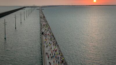 The sun rises above the Florida Keys Overseas Highway as a field of 1,500 runners competes in the Seven Mile Bridge Run, near Marathon, Florida. AFP