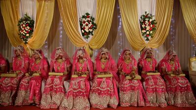 Brides sit for a mass marriage event in Mumbai, India.Rafiq Maqbool/AP