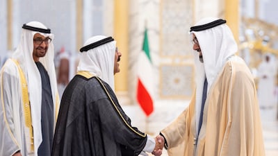 Sheikh Khaled bin Mohamed, Crown Prince of Abu Dhabi and Chairman of Abu Dhabi Executive Council, greets Sheikh Meshal, with Sheikh Mohamed looking on. Ryan Carter / UAE Presidential Court