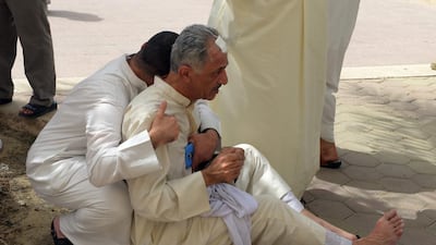 Kuwaiti worshippers are pictured following a suicide bomb attack on the Shiite Al Imam Al Sadiq Mosque in Kuwait City on June 26, 2015. Raed Qutena/EPA