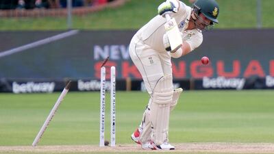 South Africa batsman Dean Elgar is bowled by England's Mark Wood. AP