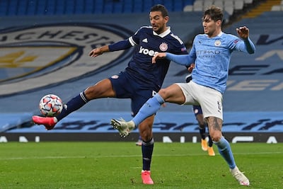 Egyptian striker Ahmed Hassan (L) vies with Manchester City's English defender John Stones during the UEFA Champions League football Group C match between Manchester City and Olympiakos at the Etihad Stadium in Manchester, north west England on November 3, 2020. AFP