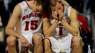 Sam Dekker, left, and Ben Brust, right, of Wisconsin react after losing to Kentucky on Saturday. Ronald Martinez / Getty Images /AFP / April 5, 2014