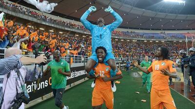 Ivory Coast forward Wilfried Bony, No 12, carries goalkeeper Boubacar Barry on his shoulders as they celebrate with forward Gervinho after winning the African Cup of Nations final in Bata, Equatorial Guinea, on February 8, 2015. Carl de Souza / AFP