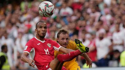 Jordan midfielder Yasen Al Bakhet, left, fights for the ball with Australia defender Ryan Grant. AP Photo