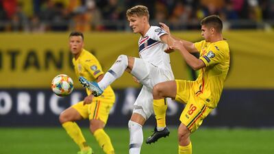 Norway's Martin Odegaard battles for the ball with Romania's Razvan Marin in October, 2019. Getty