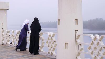 A couple pull over to take photos of the fog by the Eastern Mangroves in Abu Dhabi. Victor Besa / The National