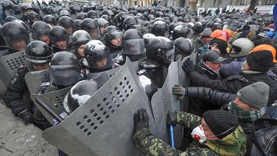 Protesters clash with riot police during an anti-government protest in downtown Kiev. Alexey Furman / EPA