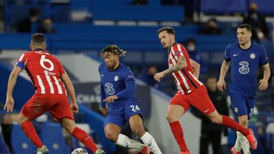 Chelsea's Reece James, second left, runs with the ball past Atletico Madrid's Koke, left, and Atletico Madrid's Saul during the Champions League, round of 16, second leg soccer match between Chelsea and Atletico Madrid at the Stamford Bridge stadium, London, Wednesday, March 17, 2021. (AP Photo/Matt Dunham)