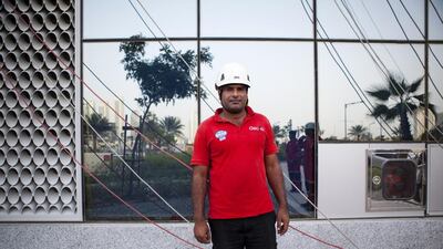 Level-3 supervisor Waheed Abdul, 34, of Pakistan, prepares to have his crew wash windows at Gate Towers on Reem Island in Abu Dhabi. Christopher Pike / The National