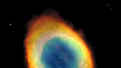 This planetary nebula's simple, graceful appearance is thought to be due to perspective: our view from Earth looking straight into what is actually a barrel-shaped cloud of gas shrugged off by a dying central star. Hot blue gas near the energising central star gives way to progressively cooler green and yellow gas at greater distances with the coolest red gas along the outer boundary. Courtesy: Nasa