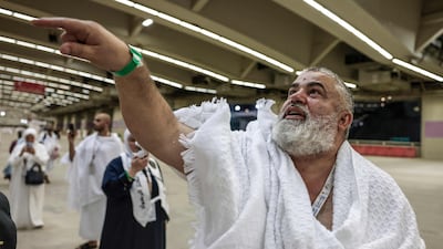 A pilgrim performs the symbolic 'stoning of the devil' ritual as part of the Hajj pilgrimage in Mina on Tuesday. AFP