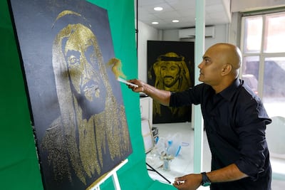Mark Ranasinghe creates a rendering of Sheikh Zayed using glitter in 2015. Victor Besa / The National