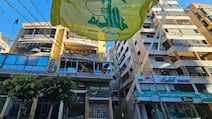 A Hezbollah flag at the site of damaged buildings following Israeli air strikes in Beirut on Thursday. The Iran-backed group has angered Lebanese by reigniting war with Israel. AFP