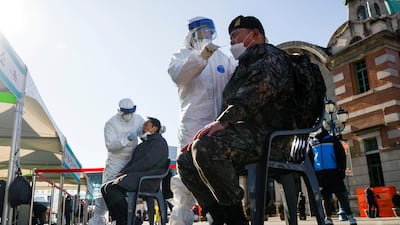 A South Korean soldier undergoes a coronavirus test at a site which is temporarily set up at a railway station in Seoul, South Korea. Reuters