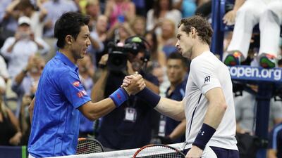 Kei Nishikori, left, and Andy Murray greet each other at the net following their five set battle in the US Open quarter-final. Justin Lane / EPA