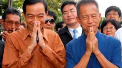 Chamlong Srimuang, right, and Chaiwat Sinsuwong, the protest leaders, meet the press after their release from jail in Bangkok yesterday.