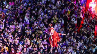 People watch a performance at a night market in Shenyang in China's Liaoning province. AFP