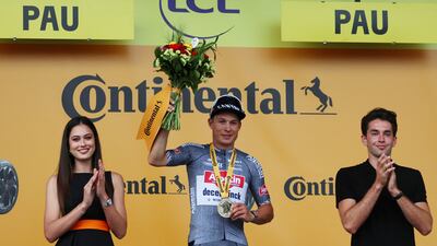 Deceuninck's Jasper Philipsen celebrates on the podium after winning stage 13 of the Tour de France. Reuters