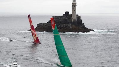 Groupama Sailing Team, skippered by Franck Cammas from France, and CAMPER with Emirates Team New Zealand, rounding the Fastnet Rock